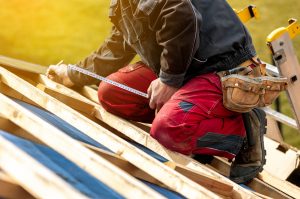 A professional roofer installing a roof on a home.