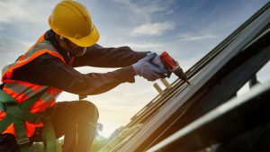 Roofer instaling a metal roof on a home.