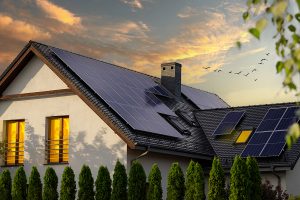 Dusk view of modern white home with solar panels on roof