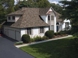 Stunning two-story home with brown asphalt shingles.